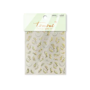 Detailed view of Tomoni vintage gold feather nail art stickers with 3D crystal accents
