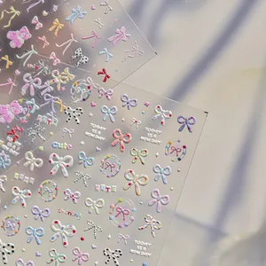 Detailed macro view of 3D embossed nail stickers with sweet colorful bow patterns