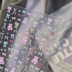 Detailed view of 3D embossed nail stickers with colorful bows and pink bears.