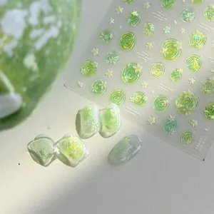 Close-up of translucent green water flower nail stickers with shell shimmer glow effect