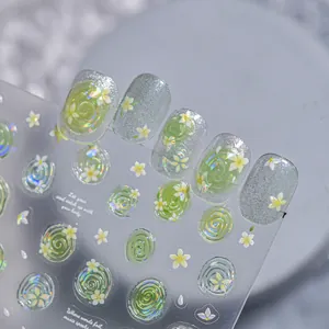 Detail view of ice translucent nail stickers with green swirl and flower patterns