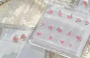 Détail de bijoux d'ongles roses de qualité supérieure avec étoiles argentées et strass
