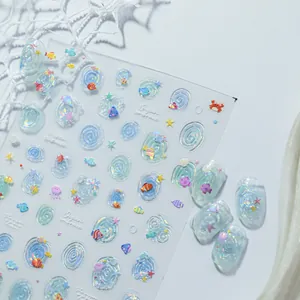 Detailed view of 3D ocean-themed jelly nail stickers with fish and shell patterns.