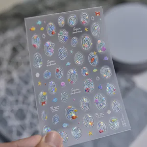 Close-up of holographic jelly shell light nail stickers with ocean fish patterns.