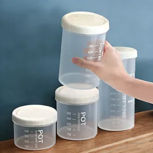 Close-up detail of transparent plastic storage jar with clear capacity scale markings.