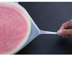 Silicone stretch lid detail showing high elasticity and flexibility covering fresh watermelon.