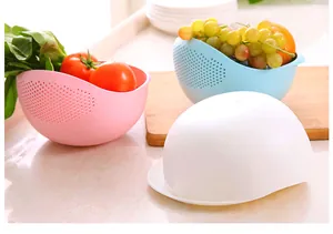Plastic drain basket detail view showing multi-color kitchen rice washing colander on counter.