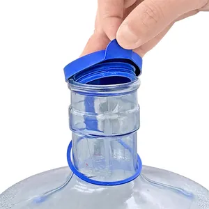 Detailed view of blue gallon water bottle dust cap with pull tab design for easy opening.