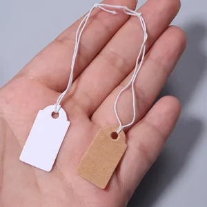 Close-up shot of blank paper price hang tags with strings, double colors for jewelry.