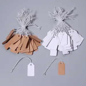 Blank paper price tags with white strings, craft paper and white labels for jewelry retail.