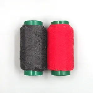 Close-up of black and red sewing thread spools, essential tool for DIY tailoring crafts detail.