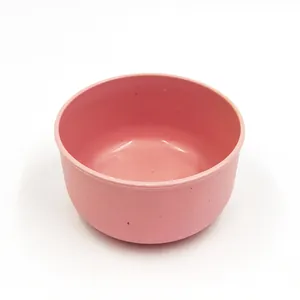 Detailed close-up view of the minimalist pink wheat straw bowl, showing smooth surface.
