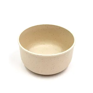 Detailed view of the wheat straw bowl, showing fine speckle texture and minimalist design.