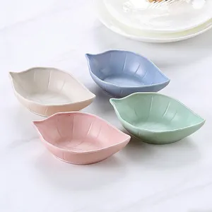 Set of four colorful leaf-shaped condiment dishes, ideal for kitchen seasoning and sauces.