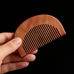 Compact peach wood half-circle hair comb for daily smooth styling and portable care