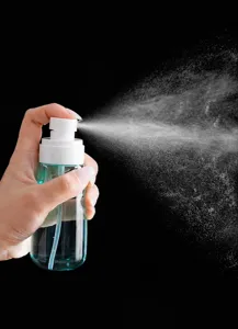 Detailed view of the portable spray bottle showing fine mist spraying action clearly.