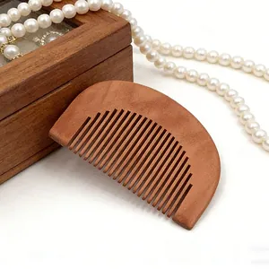 Compact wooden hair comb with smooth teeth for daily hair care, styling and scalp massage.