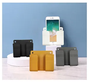 Wall-mounted phone charging holder storage box detail view, convenient punch-free remote organizer.