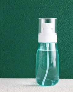 Transparent plastic spray bottle for travel cosmetics, portable fine mist atomizer container.