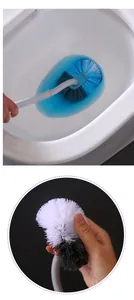 Detail view of the curved toilet brush cleaning the bowl effectively with dense bristles.