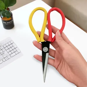 Detail shot of heavy-duty utility scissors with yellow and red handles, stainless steel blades.