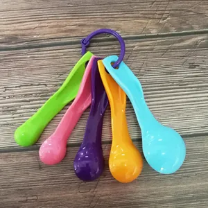 Colorful plastic measuring spoons set of 5 pieces for kitchen baking and coffee details.