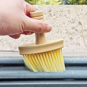 Soft bristle cleaning brush detail showing efficient dust removal in narrow gaps and air vents.