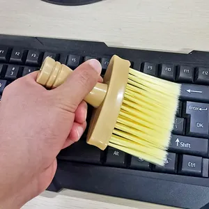 Detail view of soft cleaning brush cleaning computer keyboard, flexible bristles
