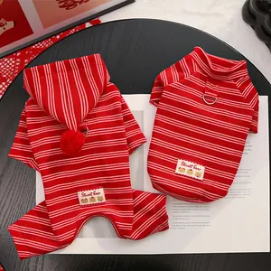 Detail view of winter pet fleece clothes, red striped dog jumpsuit and turtleneck sweater.