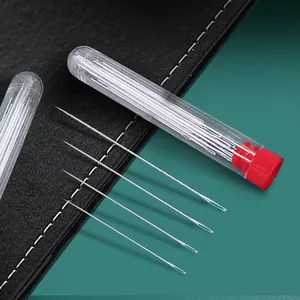 Detailed view of long steel sewing needles in a clear storage tube with red cap for crafts.