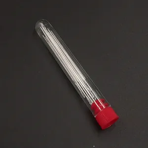 Close-up detail shot of steel hand sewing needles in a transparent tube with red cap.