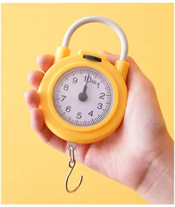 Handheld spring scale detail showing yellow body, white handle, and metal hook for easy home use.