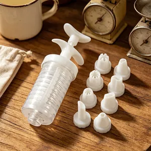 Plastic cookie press gun set with 8 piping tips for baking, kitchen tool detail view.