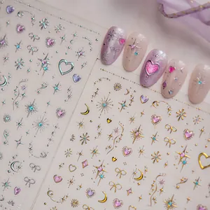 Detail of glitter starry sky nail stickers with heart and bow motifs