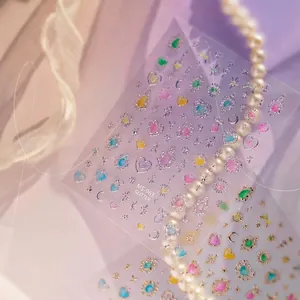 Detailed macro view of glittery ice-translucent nail art stickers with stars and hearts