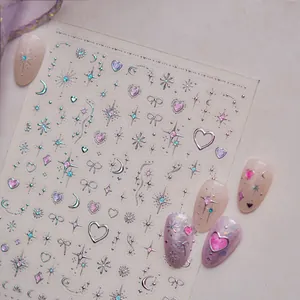 Detail view of iridescent nail art stickers with silver stars and hearts patterns