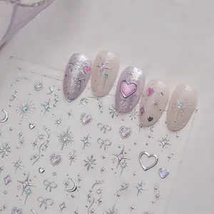 Close-up of sparkling nail art stickers with silver star and pink heart designs