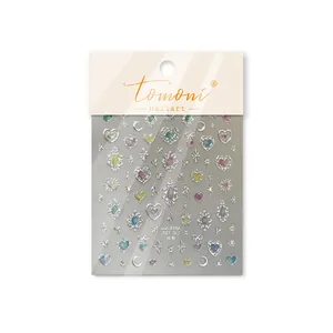 Close-up detail of Tomoni glitter nail art stickers with heart star and moon patterns