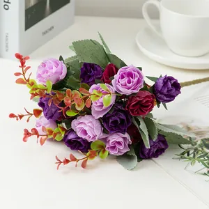 Detail shot of artificial rose bouquet with book and coffee cup props for home decor.