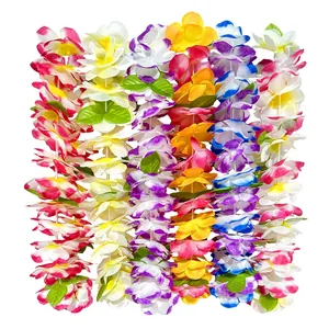 Close-up detail view of vibrant assorted Hawaiian flower leis with green leaves accents