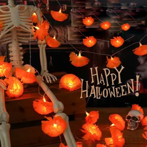 Macro detail of glowing orange marigold flower LED string lights for Halloween decor