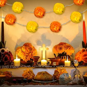 Artificial marigold garland with LED lights used in a Day of the Dead altar setup.
