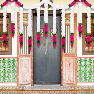 Traditional jasmine and lotus bud garlands hanging on a vintage door for Diwali decor