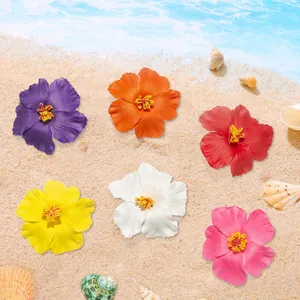 Six colorful artificial hibiscus flowers displayed on a tropical sandy beach background