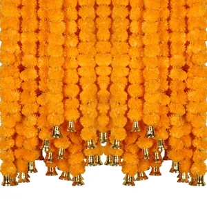 Detail view of vibrant orange artificial marigold garlands featuring shiny gold bells decor