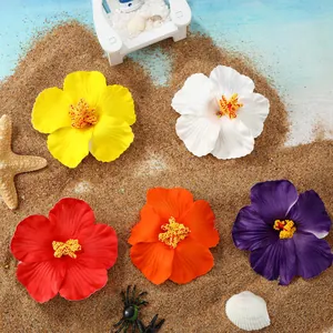 Close-up view of five vibrant artificial hibiscus flowers on a tropical beach sand background