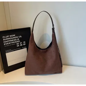 Brown suede hobo shoulder bag detail view, minimalist design, elegant daily commuter style.