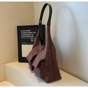 Brown suede hobo shoulder bag detail, vintage minimalist daily commute tote with front pockets.