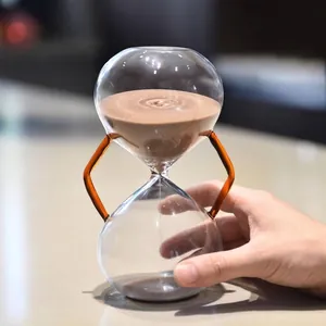 Minimalist Nordic glass hourglass with amber handles and brown sand 30 minute timer decor