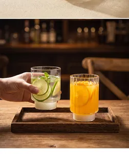 Close-up detail of ribbed heat-resistant glass cups with frosted bases on a wooden tray